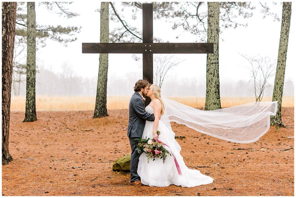 bride and groom at the cross at the rustic pine farms wedding