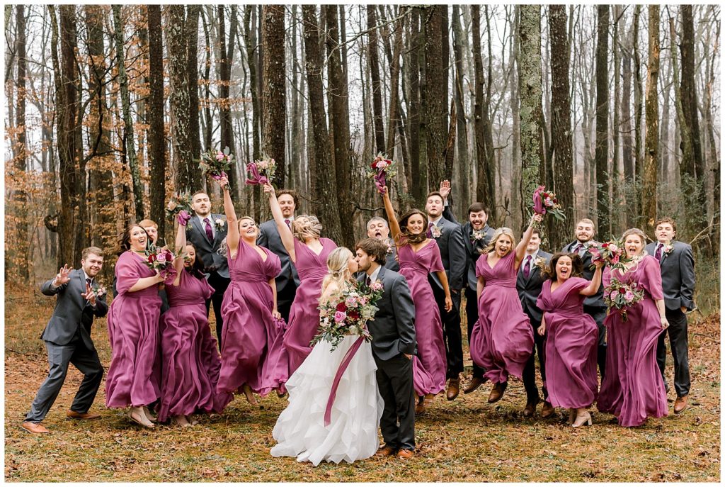 photographer captures an excited bridal party at a Rustic Pine Farms wedding