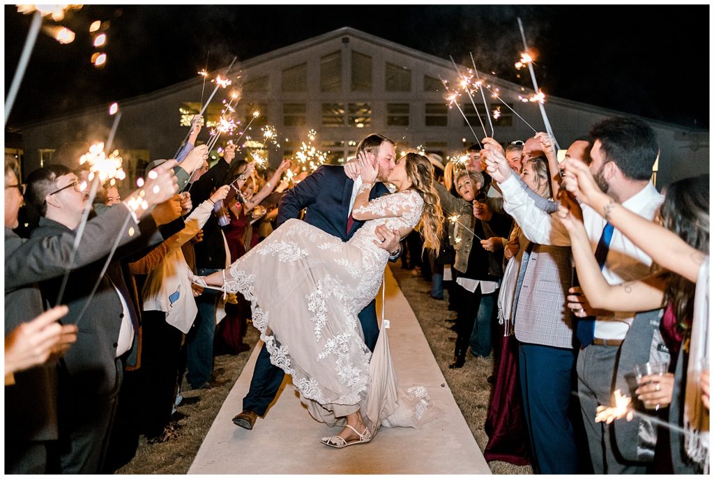 Albertville wedding photographer captures bride and groom kissing with sparklers